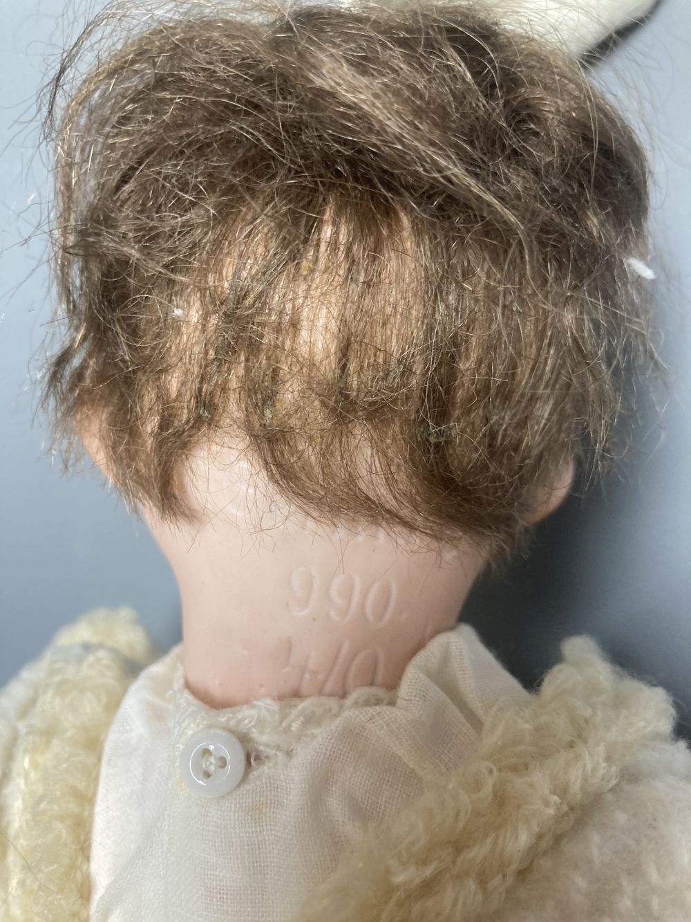 An Armand Marseille bisque boy doll, mould 990 with fixed glass eyes, 30cm, a bisque doll with jointed composition body, 47cm and a pai